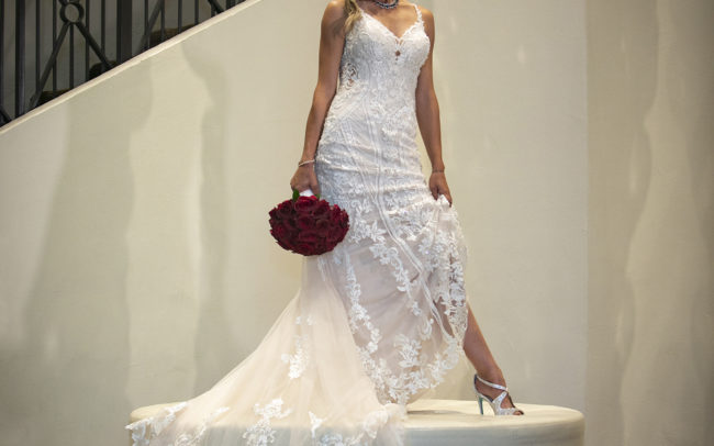 Bride standing on chair couture fashion with red bouquet PGA National Resort & Spa