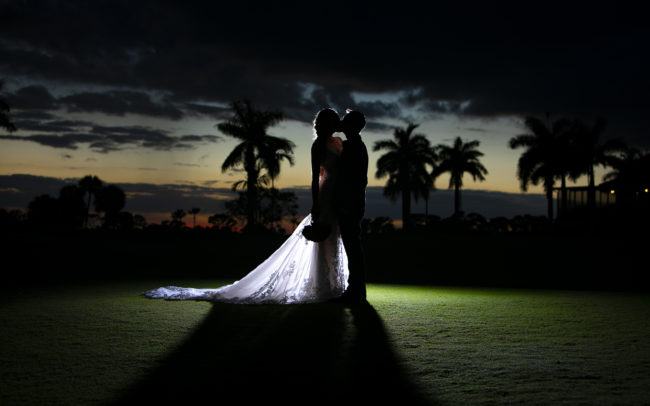 Bride and groom silhouette kissing at sunset PGA National Resort & Spa