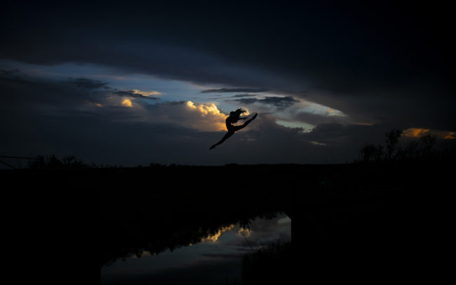 Dancer silhouette jumping at sunset