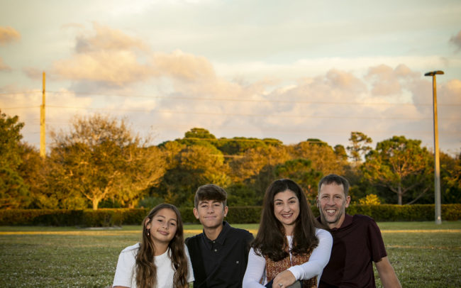 Family portrait sitting at park in Abacoa in Jupiter, Florida