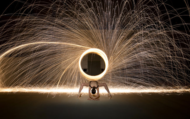 Dancer on pointe with ring of sparks behind