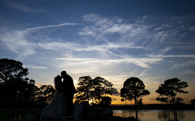 Wedding couple kissing silhouette at Ever After Farms Ranch Wedding Barn in Indiantown, Florida