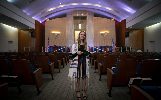 Bat mitzvah standing with whole synagogue behind at B'nai Torah Congregation in Boca Raton, Florida